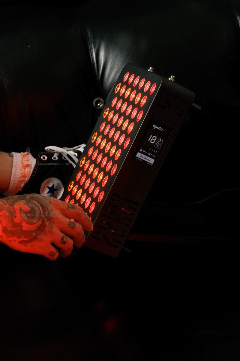 The Spalux Glow red light panel held in two hands